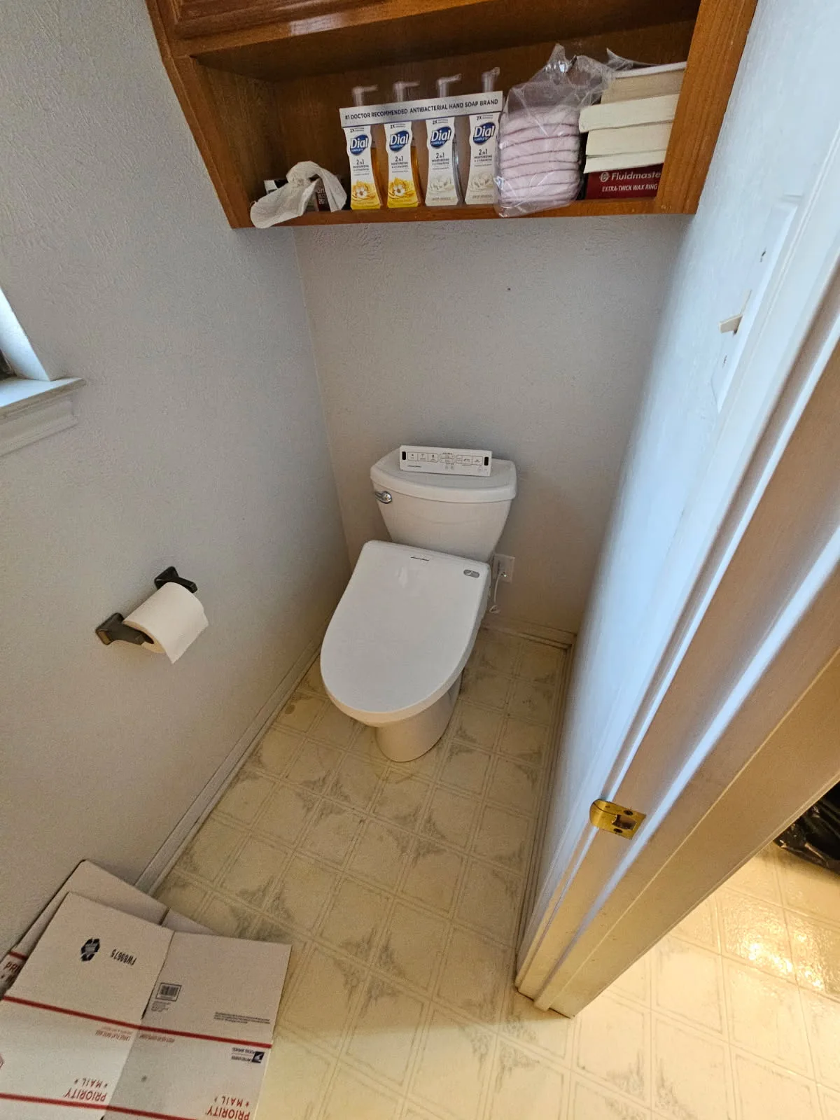 Electronic bidet seat with remote-controlled lid installed on a residential toilet in a San Antonio home — bidet installation by Out This World Services