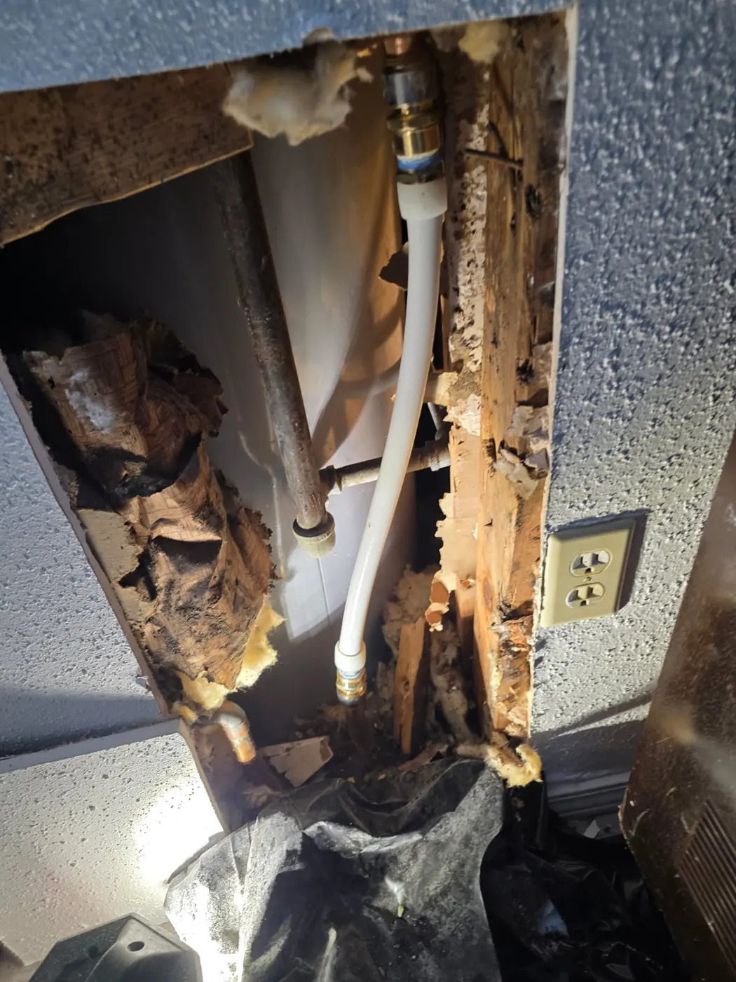 Open wall pipe repair behind a water heater — copper stub-outs, new PEX supply line and shut-off valve installed by Out This World Services in San Antonio